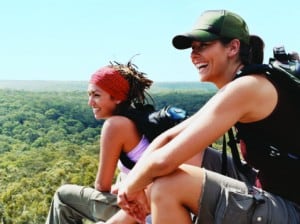 Two Young Women Relaxing From Hiking and Looking at the View Over Treetops