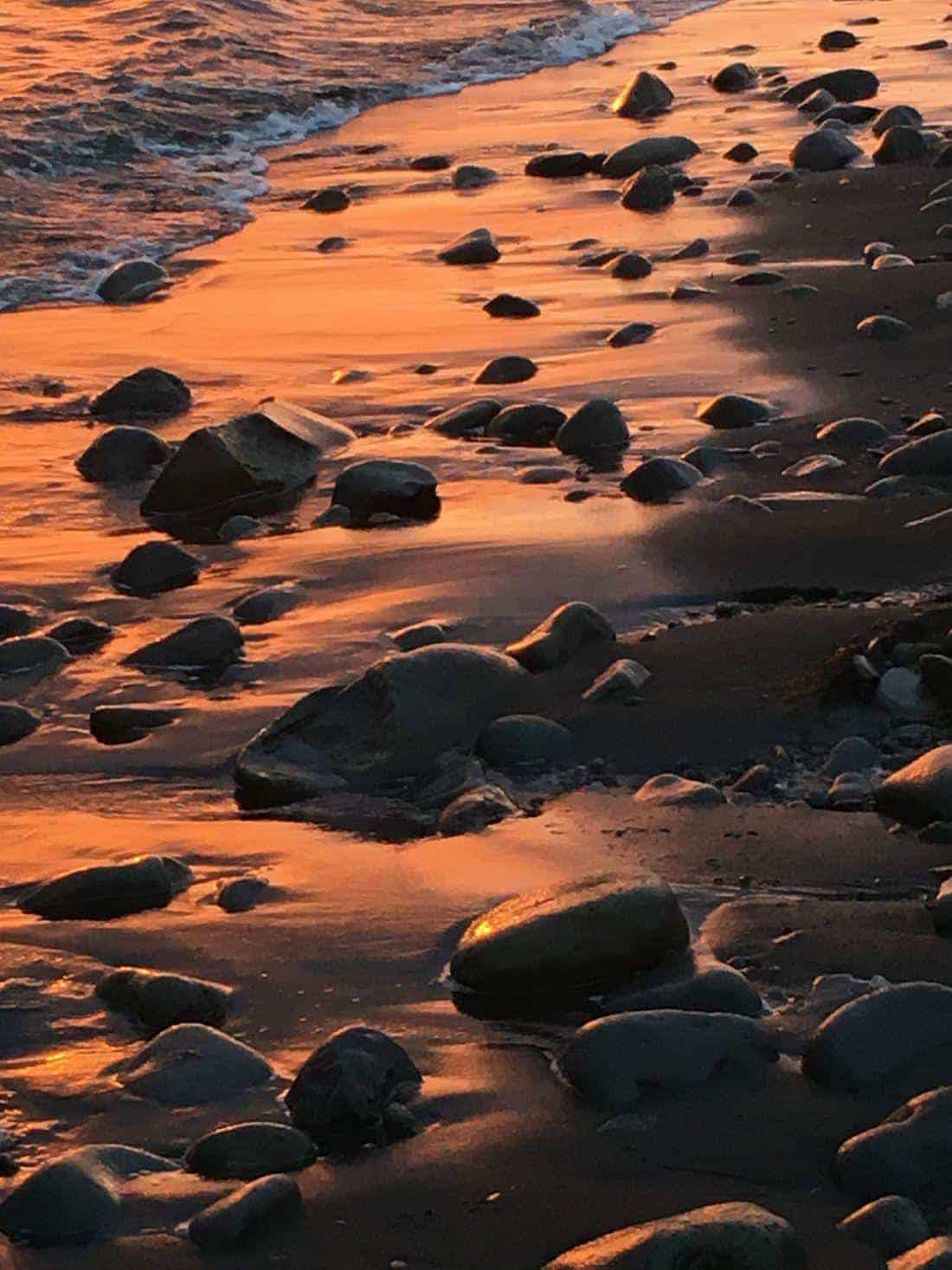 Iceland seashore hiking at sunset