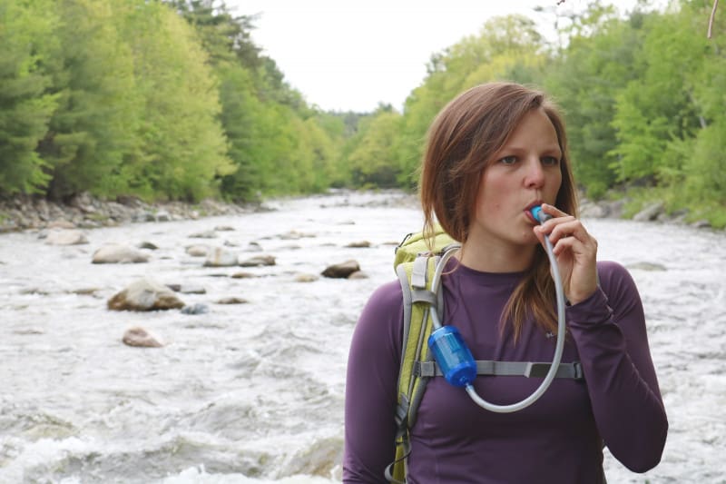 Hiker drinks freshly filtered water.