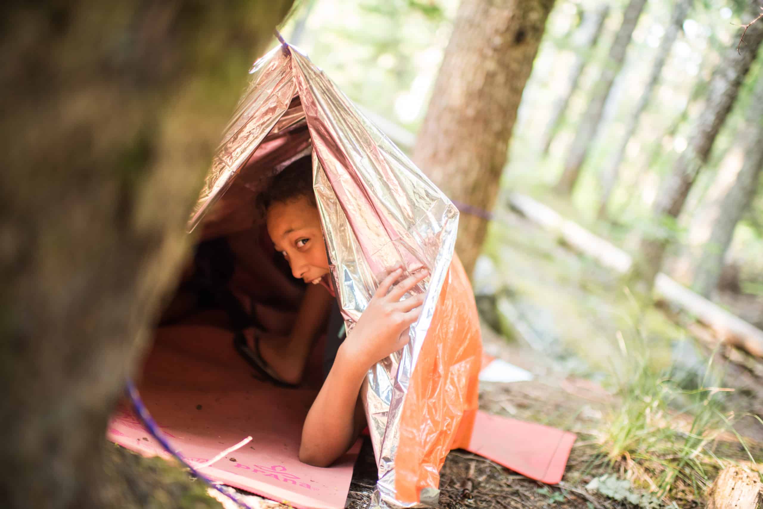 01401222SOLEmergencyBlanketyounggirlslearningtobuildshelters
