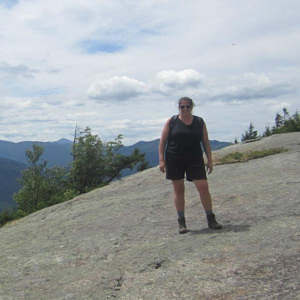 Sarah Baker Morgan-2021-cropped Sarah Baker Morgan standing on large rock slab overlook