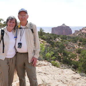 Two people stand in the Grand Canyon.