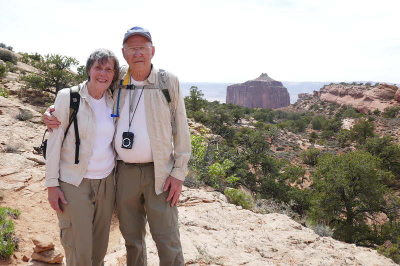 Two people stand in the Grand Canyon.