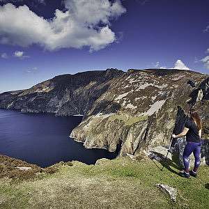 Two hikers look into the distance along the coast of the International Appalachian Trail in Ireland