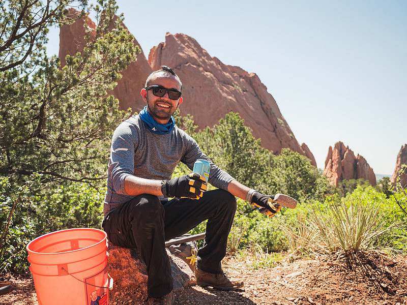 A trail volunteer takes a break with an Athletic Brewing Co non-alcoholic