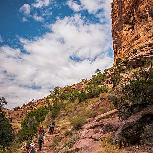 Trail volunteers hike through canyons in Moab, Utah.