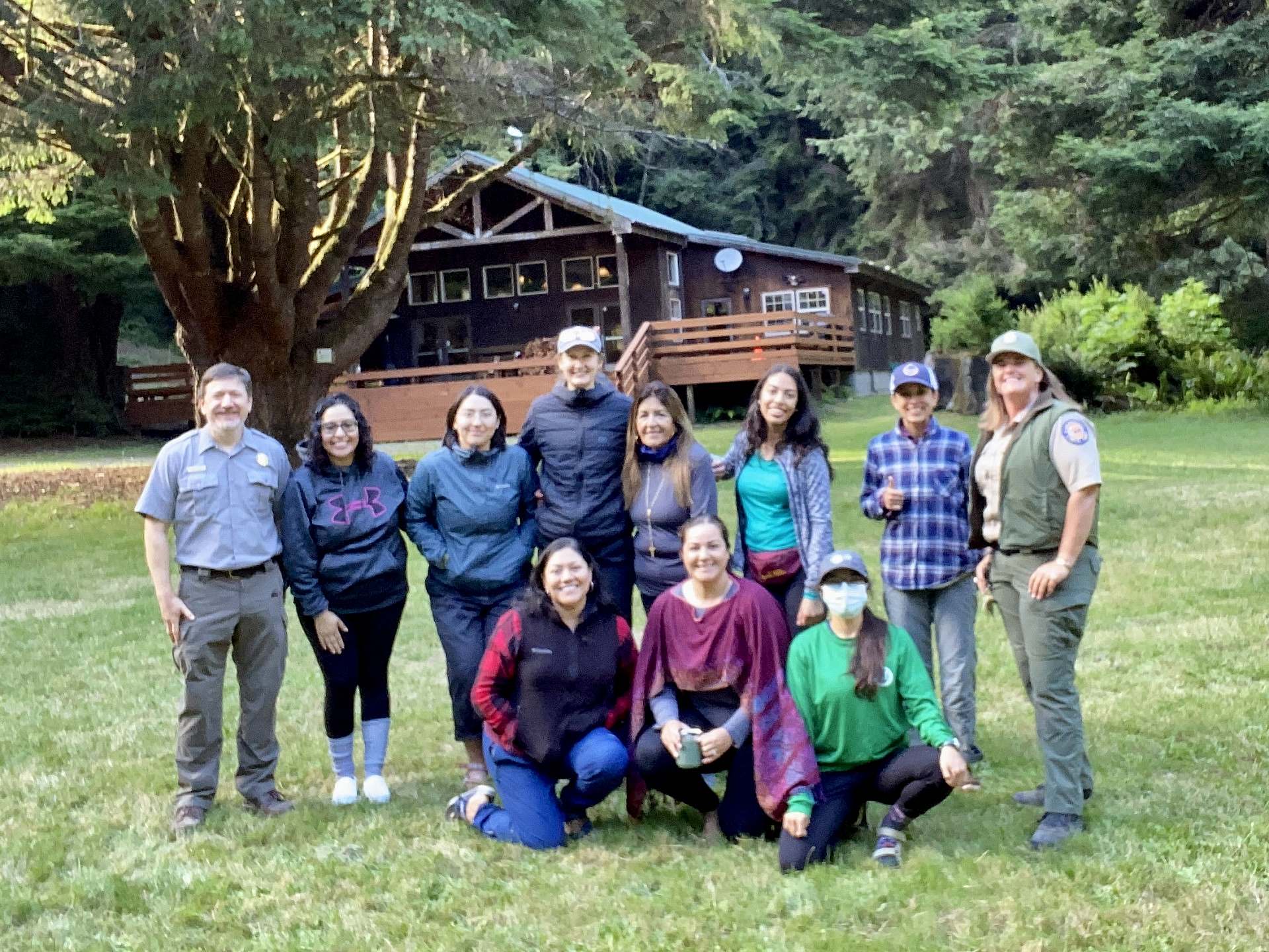 group of volunteers pose for a group photo with park officials and each end of the group