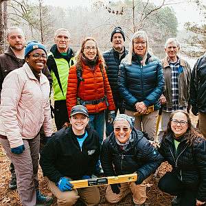 A group of trail volunteers smile for the camera in Natchez Trace State Park