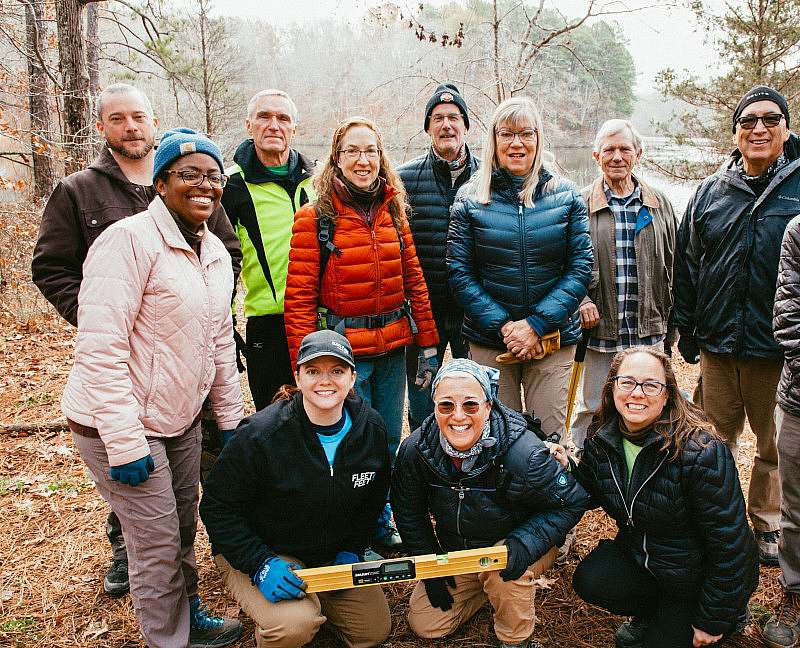A group of trail volunteers smile for the camera in Natchez Trace State Park