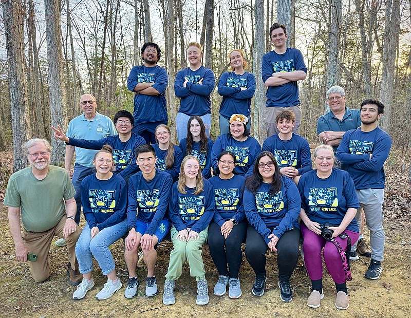 The volunteer group of 16 students with American Hiking Shirts posing with 3 Cloudland park staff in a group photo.