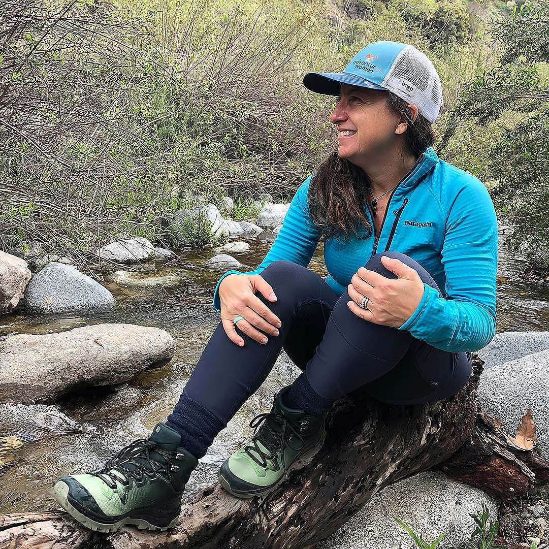 Saveria Tilden sits beside a creek